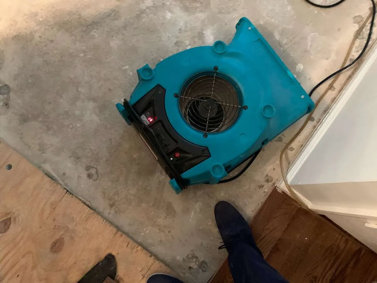 Air mover drying subfloor during Leak Detection & Repair in York